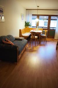 a living room with a couch and a table at Ferienwohnung für 4 Personen ca 55 qm in Inzell, Bayern Oberbayern in Inzell