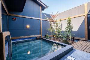 a swimming pool in the backyard of a house at Central Hotel Imari in Imari