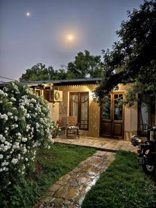 a house with a patio and a yard with flowers at Besares 722 in Chacras de Coria