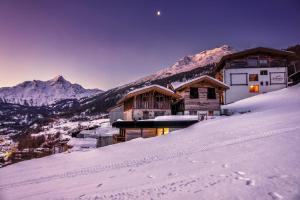 a ski lodge on top of a snow covered mountain at Ferienwohnungen direkt an der Skiabfahrt und MTB-Trails - b56870 in Sölden