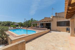 a backyard with a swimming pool and a house at Ferienhaus mit Privatpool für 6 Personen ca 120 qm in Campos, Mallorca Südküste von Mallorca in Campos