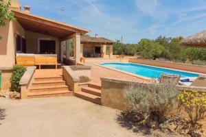 a villa with a swimming pool and a house at Ferienhaus mit Privatpool für 6 Personen ca 120 qm in Campos, Mallorca Südküste von Mallorca in Campos