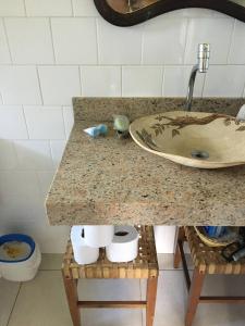 a bathroom counter with a sink and two toilets at Casinha na Represa 1 in CÃ¡ssia