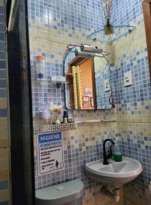 a bathroom with a sink and a toilet and a mirror at Apto com vista para Baía do Guajará in Belém