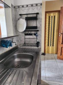 a kitchen with a stainless steel sink and a stove at Apto com vista para Baía do Guajará in Belém