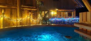 a large swimming pool with christmas lights in a room at Die Berghexn, am Klippitztörl in Bad Sankt Leonhard im Lavanttal