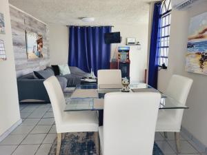 下維加的住宿－Cozy Corner w/private pool，客厅配有玻璃桌和白色椅子