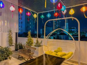 a balcony with a table and chairs and colorful lanterns at Saigon Hotel & Apartment in Ho Chi Minh City