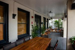 an outdoor patio with a wooden table and chairs at The 1888 Hotel in St. Petersburg