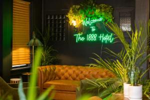 a living room with a couch and a neon sign at The 1888 Hotel in St. Petersburg +52 photos