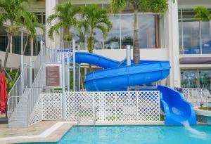 a blue water slide in a swimming pool at Lotte Hotel Guam in Tumon