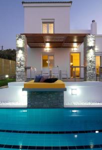 a villa with a swimming pool in front of a house at Villa Alexandra - Komfort mit eigenem Pool in Loutra