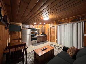 a living room with a couch and a table at Rustic 1 bd 1 ba Cabin at New Waitts Lake Resort in Valley