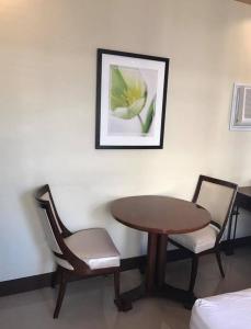 a room with a table and two chairs and a picture at Star hotel in San Pablo