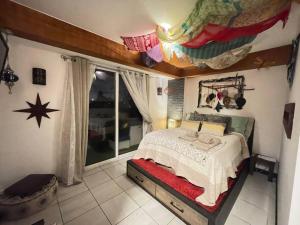 a bedroom with a bed and a large window at Bonito apartamento en zona 1 Ciudad de Guatemala in Guatemala