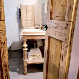 een badkamer met een wastafel en een houten stoel bij Ferienhaus für 5 Personen ca 70 qm in San Leo, Emilia-Romagna Provinz Rimini in San Leo