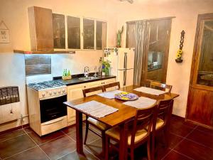 a kitchen with a table and a stove and refrigerator at Besares 722 in Chacras de Coria