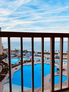 a view from a balcony of a resort with blue pools at Porto Sokhna Red Sea in Ain Sokhna