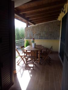 a wooden table and chairs on a patio at Oasi Peppa in Ascea