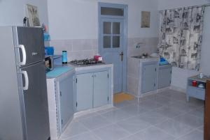 a kitchen with a refrigerator and a sink in it at Élégant Studio in Meknès