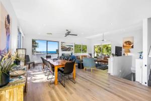 a dining room and living room with a table and chairs at Peregian Beach Holiday House & Resort Pet Friendly in Peregian Beach