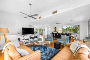 a living room with a couch and a table at Peregian Beach Holiday House & Resort Pet Friendly in Peregian Beach