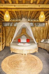 a bedroom with a bed in a wooden room at Eco Bamboo Island Bali - Bamboo House #4 in Selat