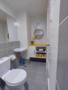 a bathroom with a white toilet and a sink at Palawan Paradise Condotel 6F in Puerto Princesa City