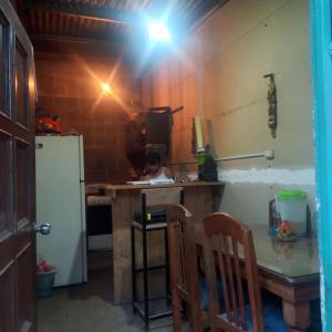 a kitchen with a table and a refrigerator at coraizone hostel in Cobán