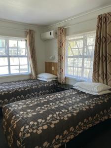 Postel nebo postele na pokoji v ubytování Tudor Motor Lodge