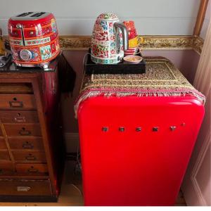 a red suitcase with a table on top of it at Chinoiserie in Katoomba