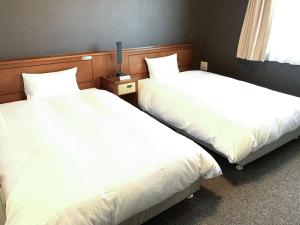 Postel nebo postele na pokoji v ubytování Hotel Route-Inn Mikawa Inter