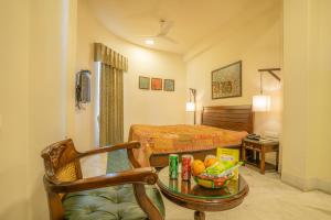 a hotel room with a bed and a table at Tripli Hotels Shambhu Villas in Udaipur