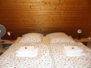 a bed with two towels on top of it at Ferienhaus in Kuhklingen mit Großer Terrasse in Wald-Michelbach