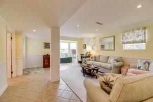 a living room with two couches and a table at Heron House by Brightwild - Luxury Waterfront Home in Key West