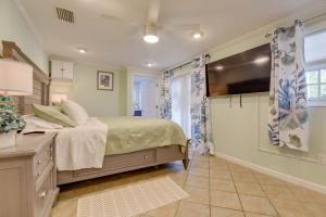a bedroom with a bed and a ceiling fan at Heron House by Brightwild - Luxury Waterfront Home in Key West