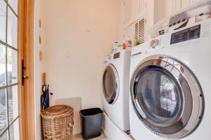 a washing machine in a laundry room with a window at Heron House by Brightwild - Luxury Waterfront Home in Key West