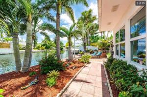 a house with palm trees and a swimming pool at Heron House by Brightwild - Luxury Waterfront Home in Key West