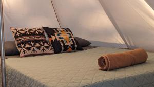 a bed in a tent with pillows on it at La Window Glamping in La Ventana +62 photos