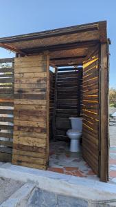 a wooden outhouse with a toilet in it at La Window Glamping in La Ventana