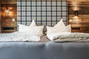 two beds with white sheets and pillows on them at Ferienwohnungen direkt an der Skiabfahrt und MTB-Trails - b55932 in Sölden