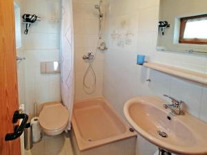 a bathroom with a sink and a toilet and a shower at Haus Kees- Apaartement in Kressbronn am Bodensee in Kressbronn am Bodensee
