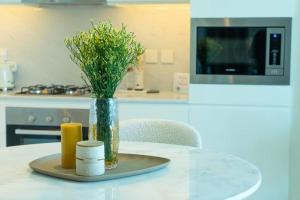 a vase of flowers on a table in a kitchen at The Palace I Luxury 2BD I Dubai Creek Harbour in Dubai