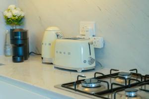 a kitchen counter with a stove and a toaster at The Palace I Luxury 2BD I Dubai Creek Harbour in Dubai