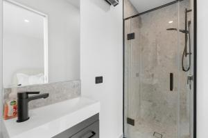 a bathroom with a shower with a glass door at Modern Sunny 3Bed 2.5Bath in Christchurch