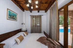 um quarto com uma cama e uma grande janela em Villa Wish mit beheiztem Pool em Svetvincenat