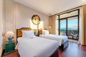 Postel nebo postele na pokoji v ubytování Hadana Boutique Resort Hoi An