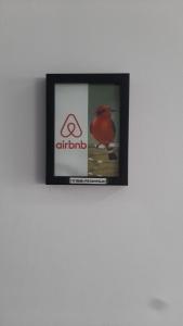 a picture of a red bird on a wall at Suite con hamaca y baño privado. in Manizales