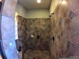 a bathroom with a shower with a shower at Humble Home in San Antonio