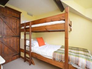 a bedroom with two bunk beds in a room at 3 Bed in Conwy TYPLL in Llangelynin